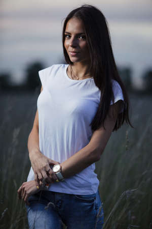 Beautiful young woman outdoors in evening time.の写真素材