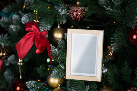 Empty picture frame placed on the christmas treeの写真素材