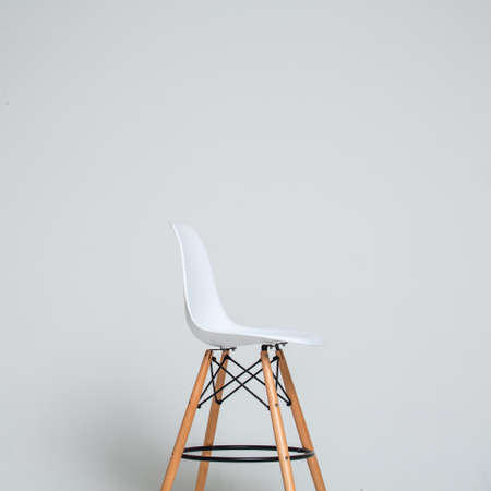 Stylish modern white chair furniture over the light grey background with copy space for your textの写真素材