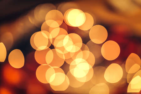 Christmas bokeh light abstract holiday background, yellow red and black colours
