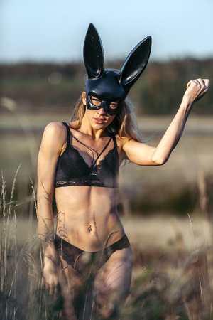 Beautiful Sexy Woman Wearing Black Fashion Bunny Mask Outdoorsの写真素材