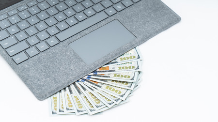 laptop computer and cash  isolatedの写真素材
