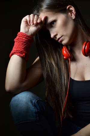 A beautiful young woman with the red headphones の写真素材