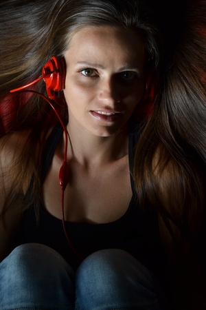 A beautiful young woman with the red headphones の写真素材