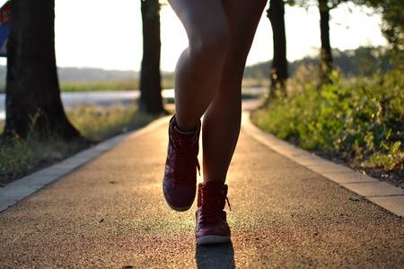  young woman walking in the park , legs close upの写真素材