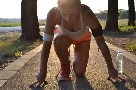 young woman working out in the park at sunset or sunriseの写真素材