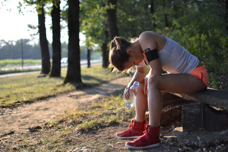  young woman resting in the park after the workoutの写真素材
