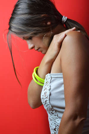 beautiful young woman posing against red background