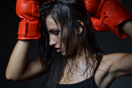 beautiful woman with the red boxing gloves, studio shotの写真素材