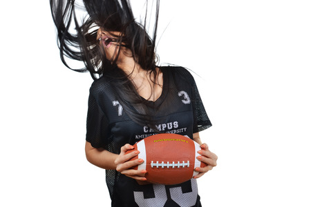 beautiful young woman, american football concept, studio shot の写真素材