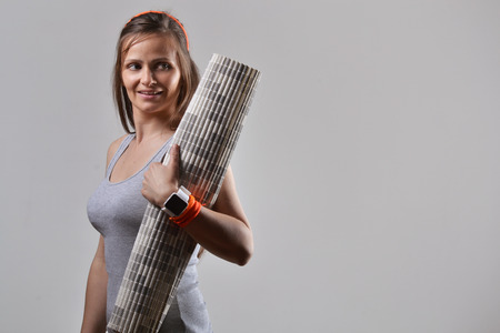 fitness woman holding exercise matの写真素材