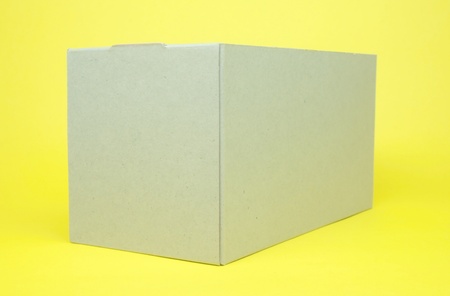 Cardboard box  isolated on yellowの写真素材