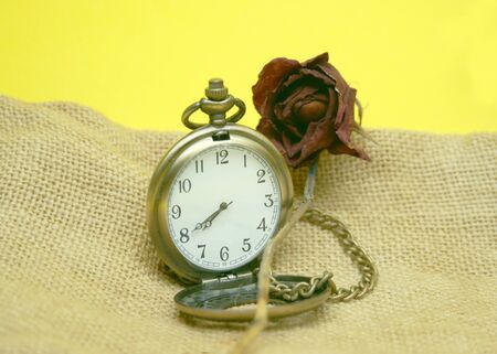 watch and dead rose on burlapの写真素材