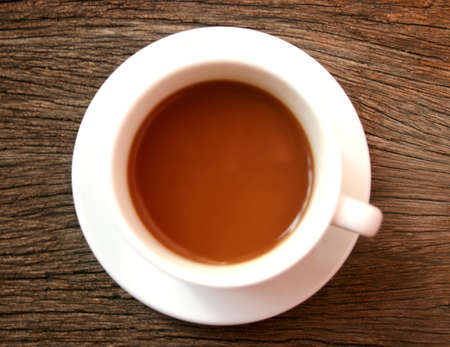 coffee in a white cup on wooden の写真素材