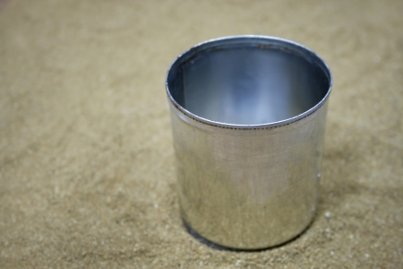 A silver tin can on sandの写真素材