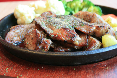 Grilled steaks and vegetable saladの写真素材