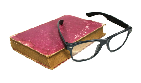 Old book and glasses on a white backgroundの写真素材