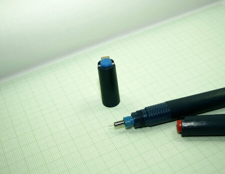 pen on green graph paperの写真素材