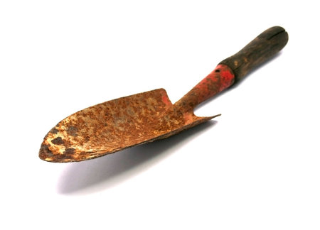 Small rusty shovel isolated on white