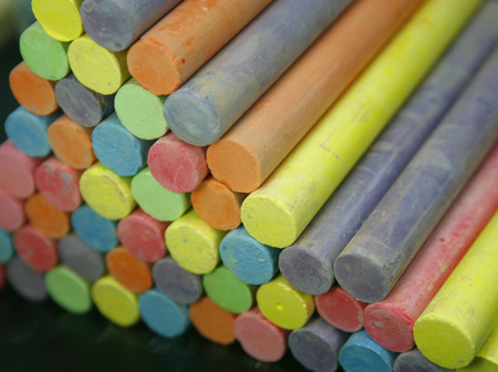 Set of colorful pieces of chalk on blackboardの写真素材