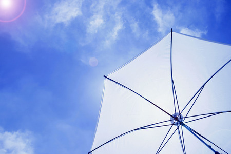 sun umbrella in blue sky with sunny shineの写真素材