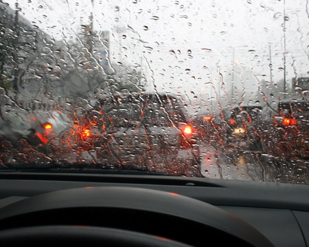Road view through car window with rain drops, Driving in rain.の写真素材