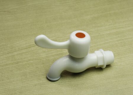 White Faucet on Wood Tableの写真素材