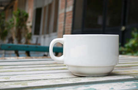 Coffee cup on wood table with blur background