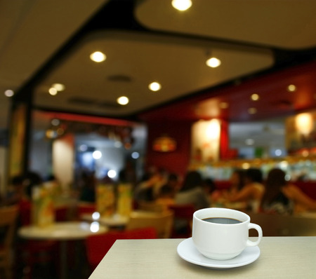 Blurred background : white cup of coffee and customer at restaurant blur background with bokehの写真素材