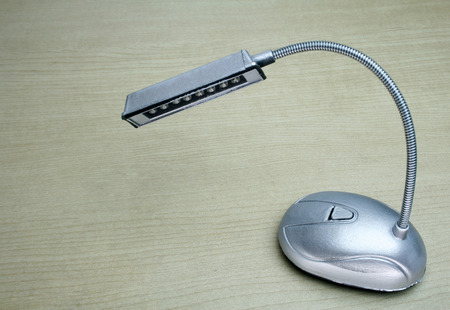 desk lamp on wood table backgroundの写真素材