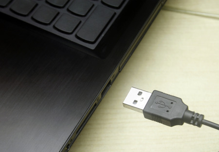 USB cable plugging in to laptop
