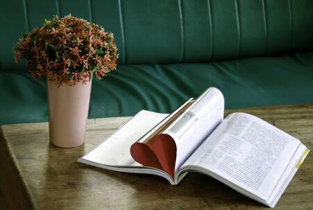 Heart from book pages with flower in vaseの写真素材