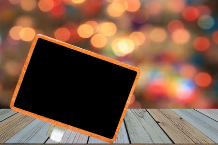 blank blackboard on wood with defocused backgroundの写真素材