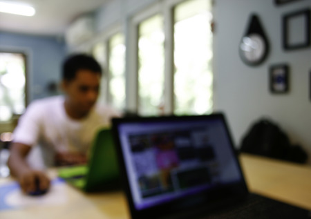 Blurred man with laptop at cafe background, business , technology conceptの写真素材