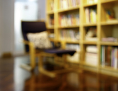 Blurred books on the shelf in public library. Blurred effect. Background for your picturesの写真素材