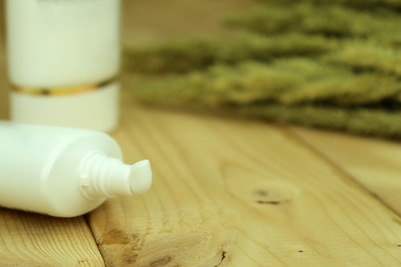 Close up of a white cream tube on wood