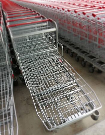 row of shopping trolleys or carts in supermarket