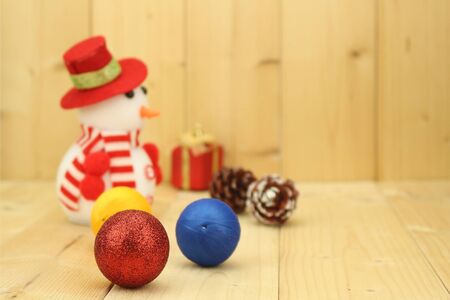Blured toy snowman  is standing beside christmas decorationの写真素材