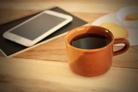 coffee cup and office desk with laptop computerの写真素材