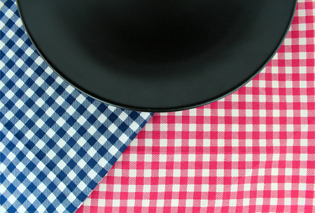 the plate on checkered tableclothの写真素材