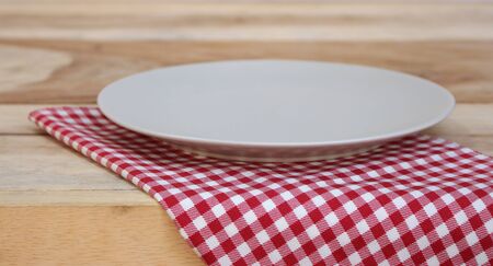 the plate on checkered tableclothの写真素材