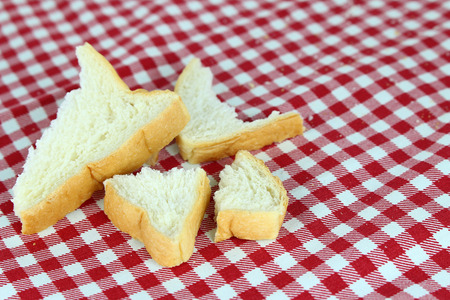 crumb of bread on tablecloth