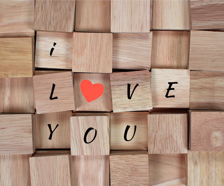 wood background : message I love you spelled in wooden block