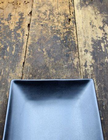 Empty dish plate on wooden background