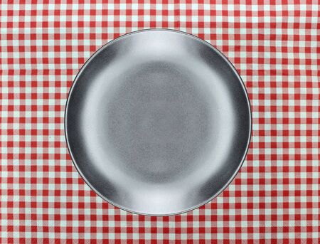 the plate on checkered tableclothの写真素材