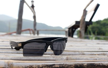 selective focus sunglasses on bamboo floor in vintage styleの写真素材