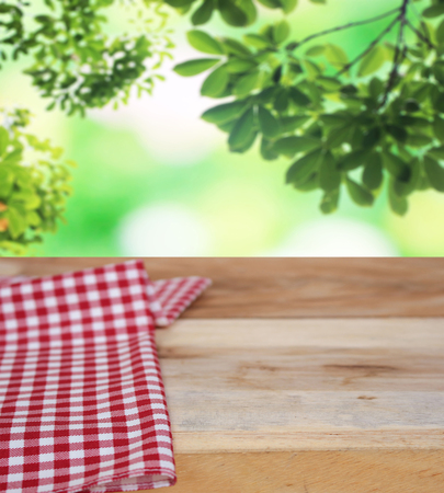 checkered tablecloth and blur leaves backgroundの写真素材