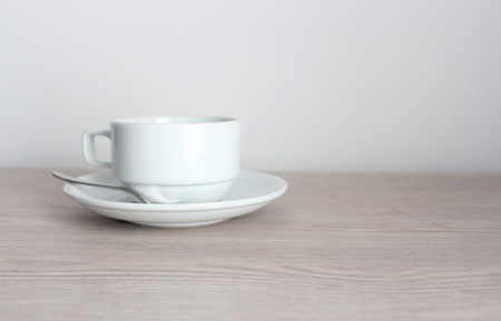 coffee cup and saucer on wooden tableの写真素材