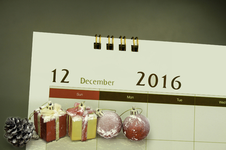 Christmas decorations and gift boxes with calendar page of month 2016の写真素材