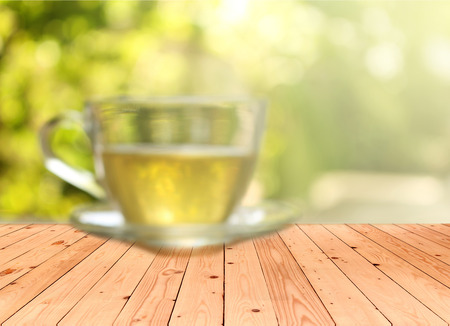 Blurred background : Cup of tea on a blurred background of nature with burst lightの写真素材